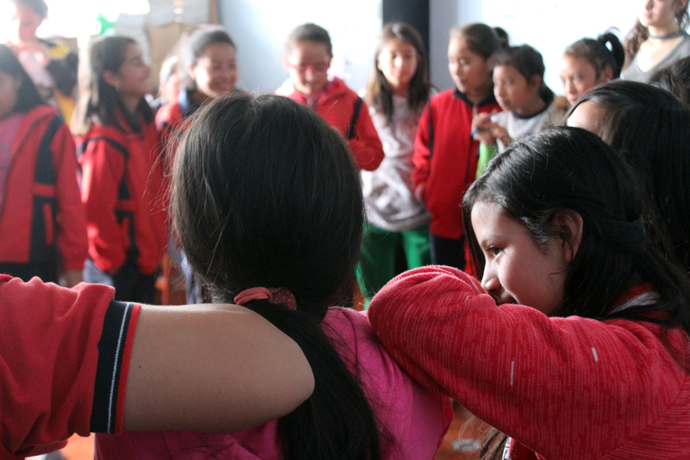 Girls leaning on one another during a boxing workshop led by Jovenes Por El Cambio in Mexico