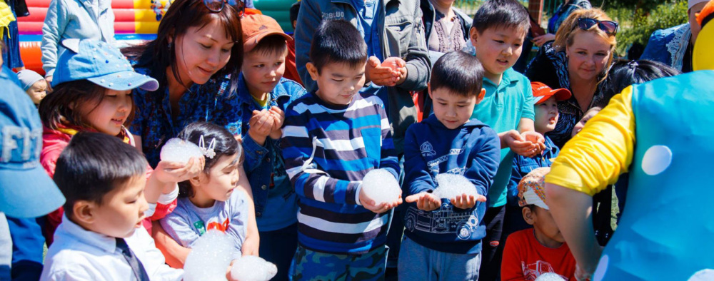 A group of children participate in an outside activity.