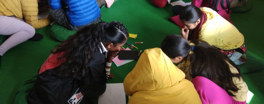 Participants seated on the floor during an Asha Nepal program.