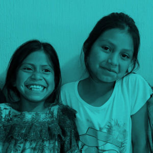 Girls in Guatemala smiling and laughing.