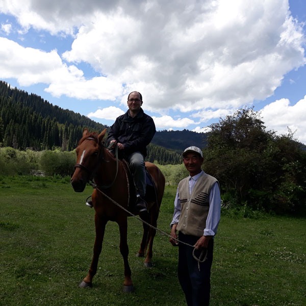 Joseph Bednarek, GFC’s Senior Director of Global Grantmaking, on a horse.