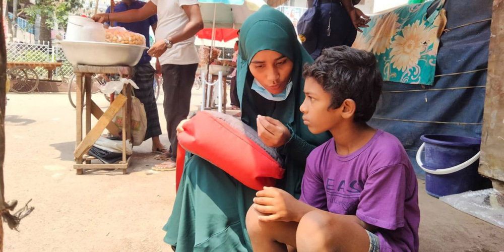 A LEEDO outreach worker talks to a child.
