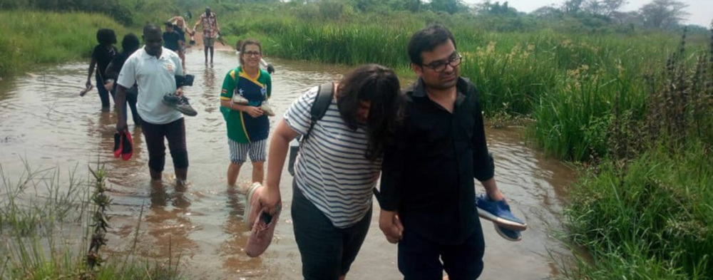 Step Up participants crossing water in Uganda