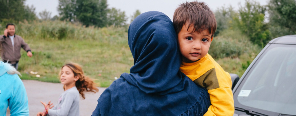 A refugee mother holding a child