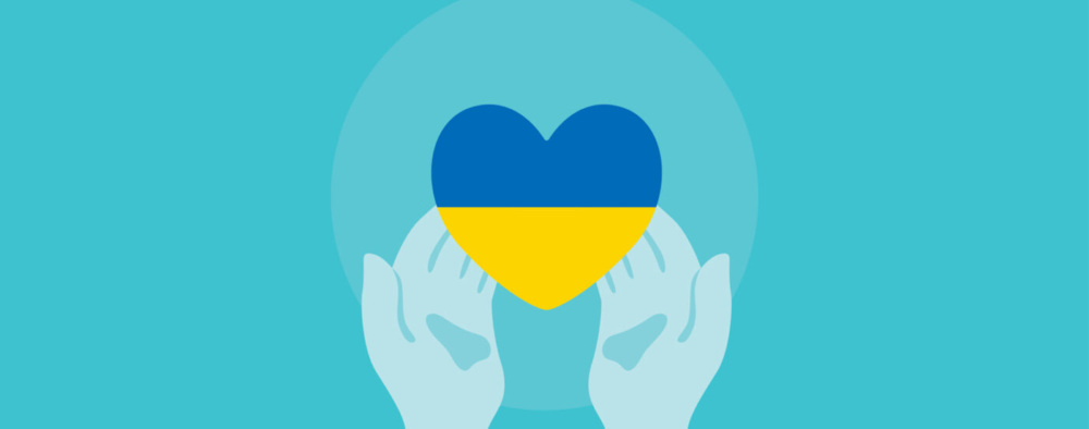 Blue hands holding a heart with the colors of the Ukrainian flag