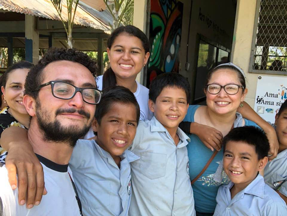 Rodrigo Barraza poses with children and organization staff on a visit to a partner