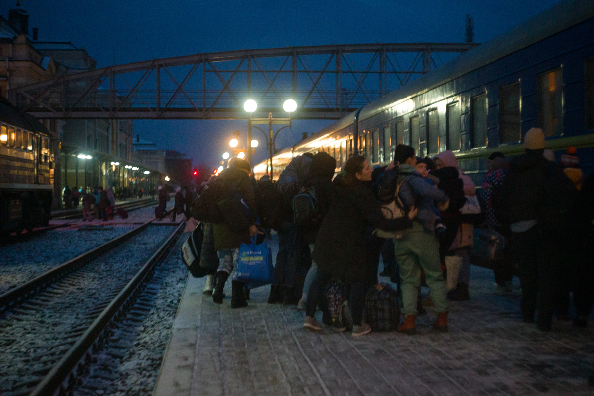 People at a train station in Ukraine at night