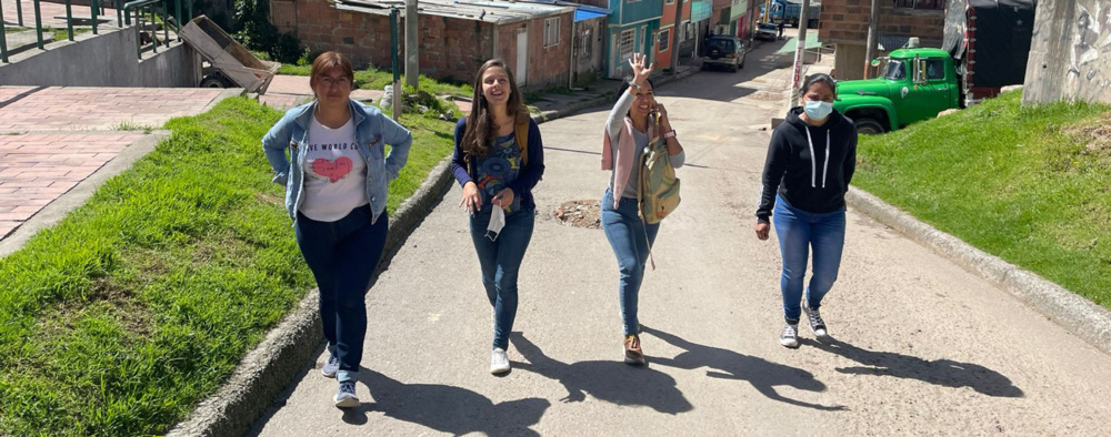 Four people walking on a road