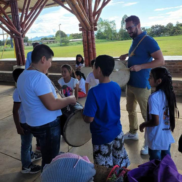 Children and GFC staff learning how to play drums