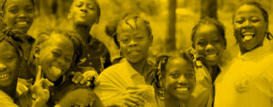 Girls smiling outside at GFC partner WAVES in Sierra Leone.