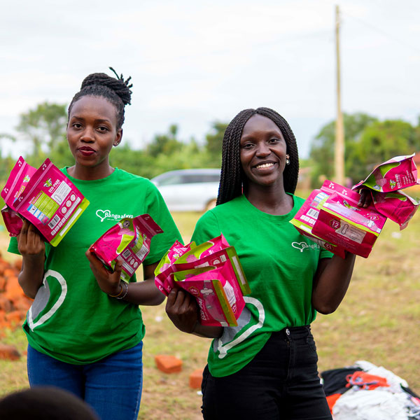Two girls posing with reusable pads