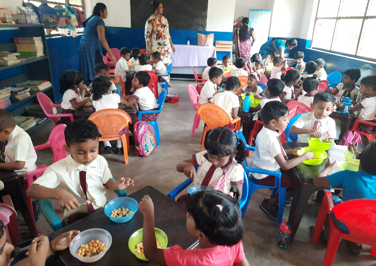 Children enjoying a meal of chickpeas. 