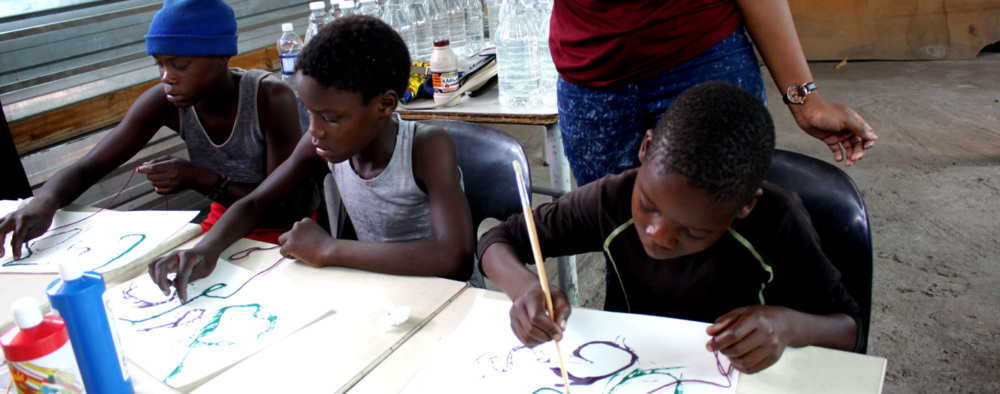 Three children doing art