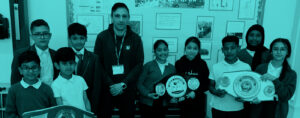 A group of children posing with their boxing belts and awards