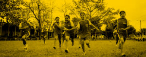 A group of young girls running in a sports field