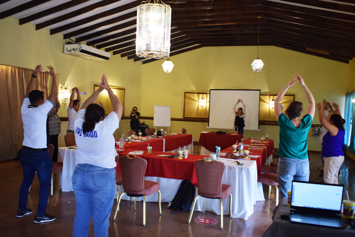 Participants at the SEED convening in Honduras doing simple stretches