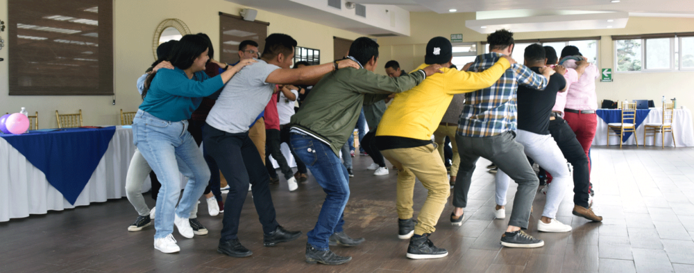 Participants in dance holding each other's shoulders