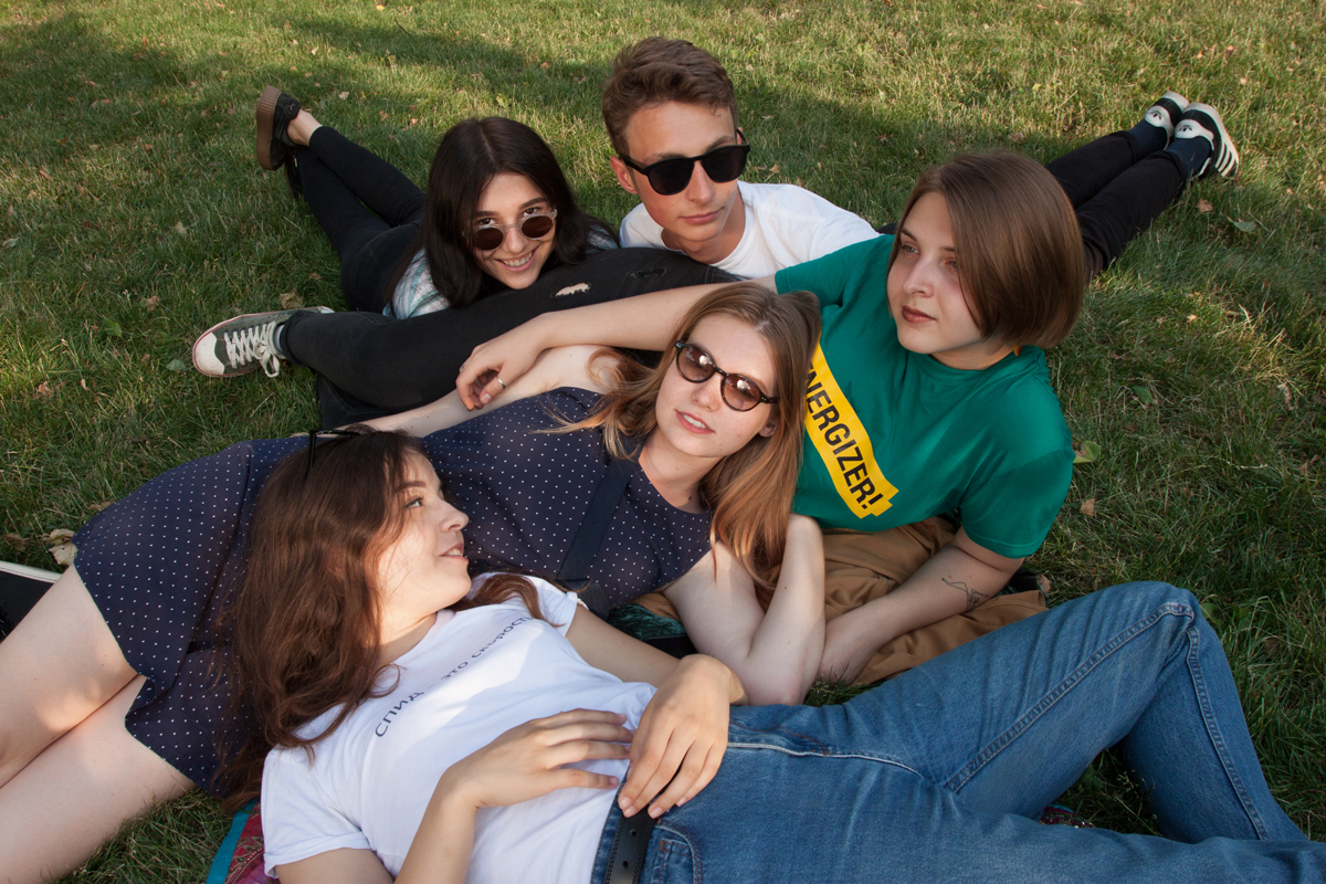 Young people lying in a grassy field