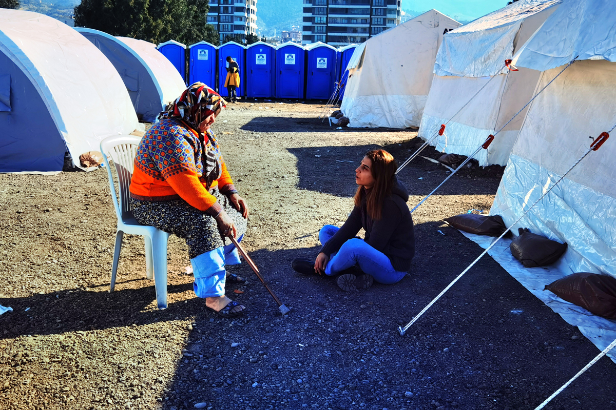 Two women speaking in a camp in Turkey