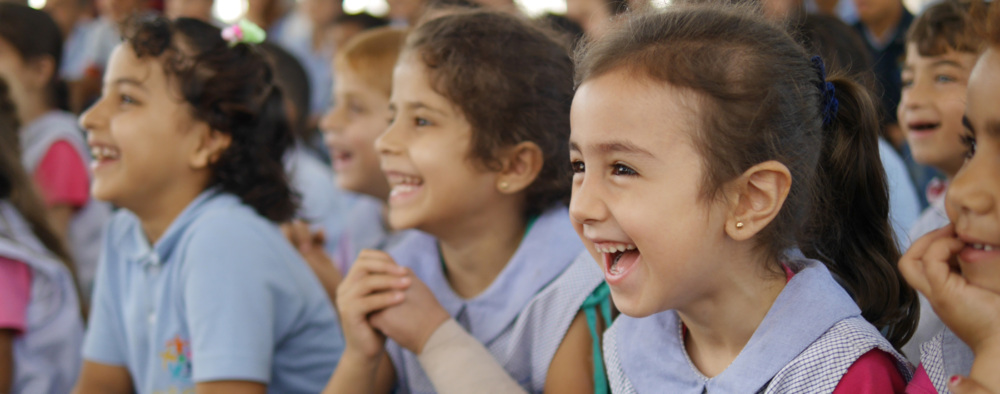 A group of young children, laughing.