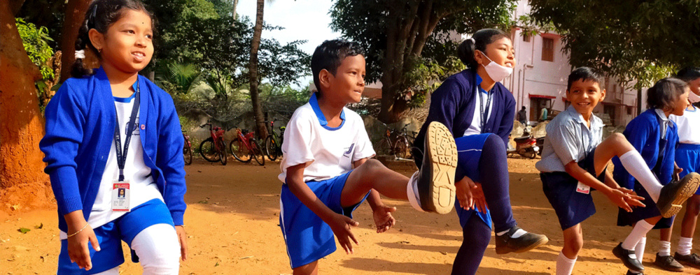 Children take part in a sports exercise, outdoors.