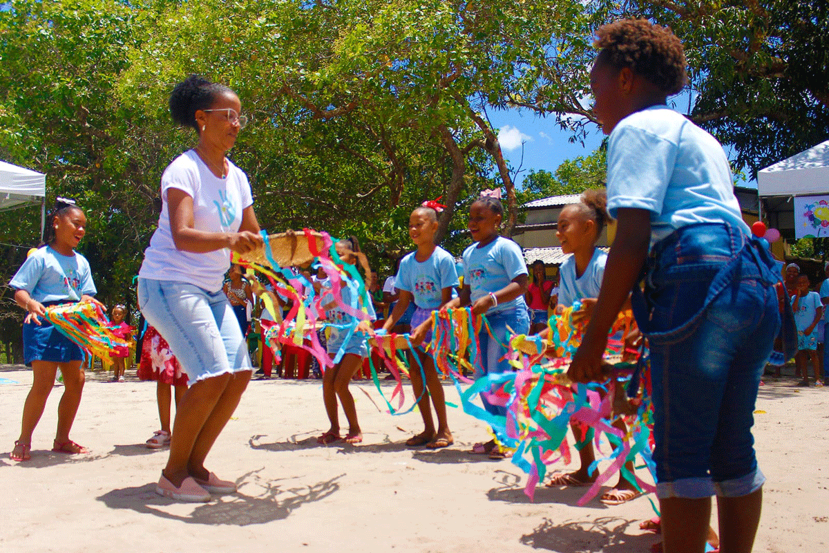 Children dancing and playing with colourful items made of crepe material