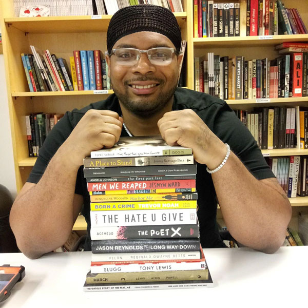 Jameon with books: Free Minds member Jameon, home from prison, with a few of his favorite books
