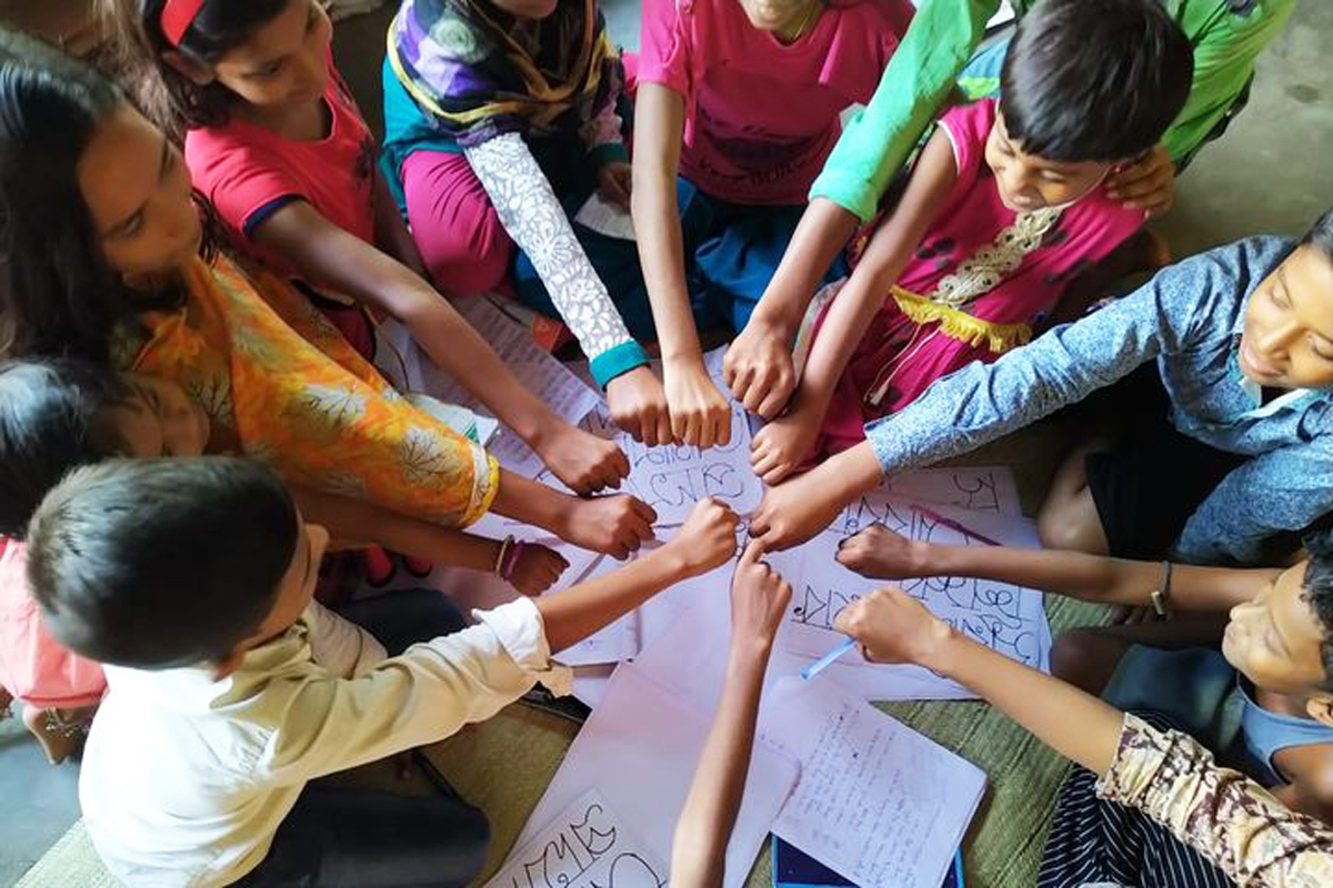 Children making a circle with their hands and fists