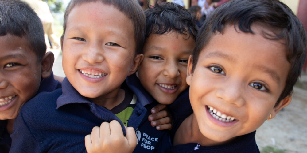 4 little children beaming into the camera