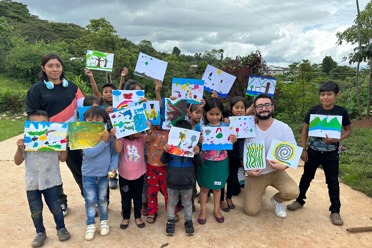 A group of children with their artwork. 