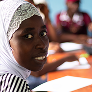 Young woman looking at the camera while in the classroom.