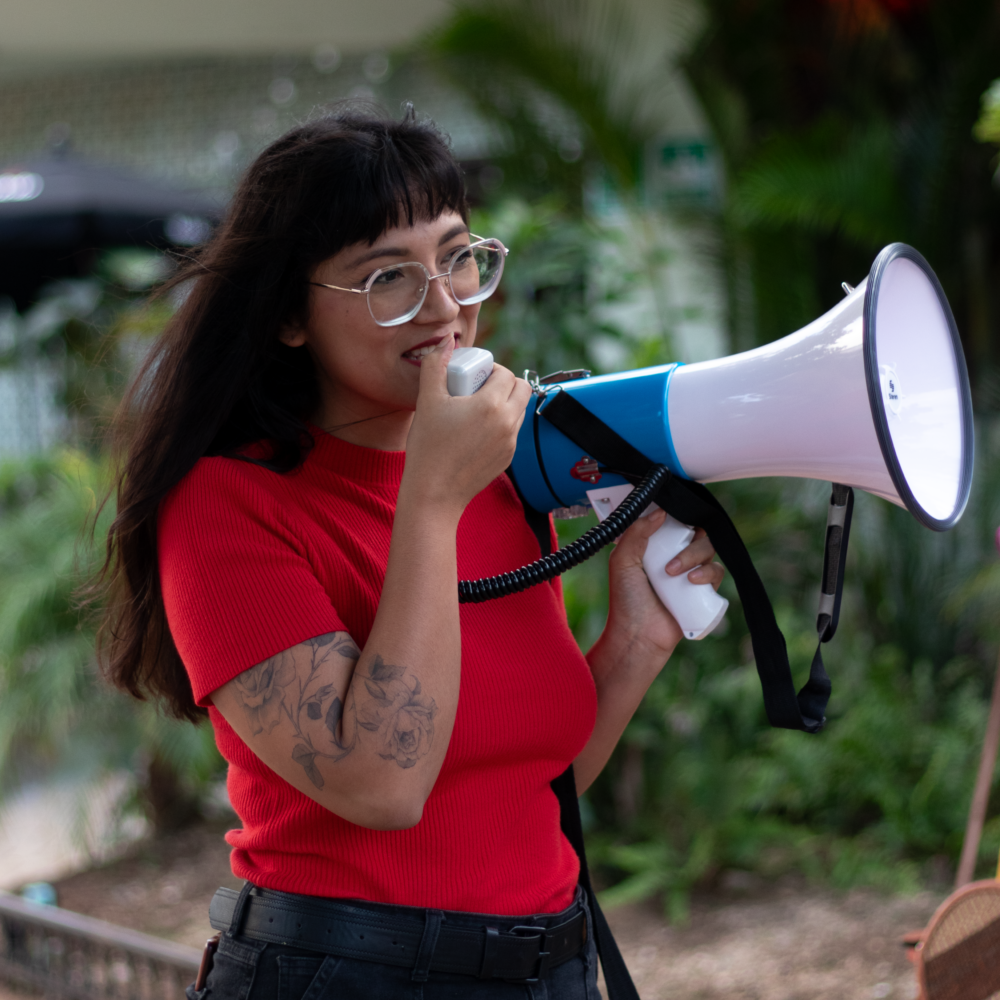 Young woman speaking into megaphone in Mexico.