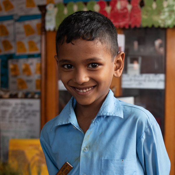 A school boy smiling at the camera