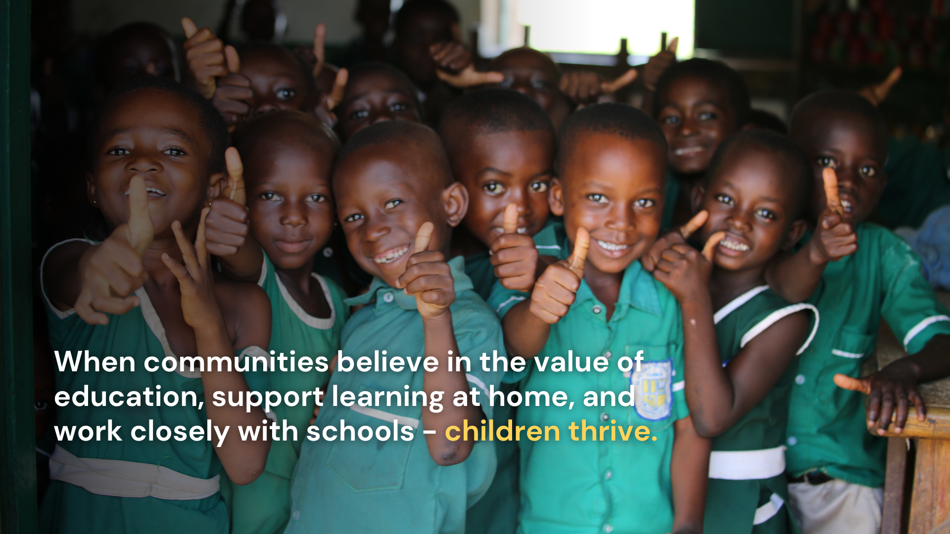a group of young school children from Ghana in their green school uniforms, grouped together smiling at the camera